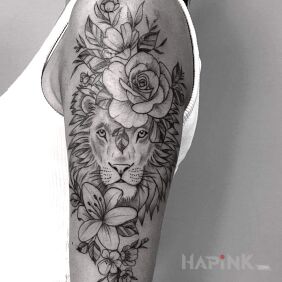 Tattoo Feminine lion in flowers On the arm motif: black and gray style: graphic / illustrative