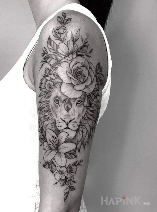 Tattoo Kobiecy lew w kwiatach in floral motif and graphic / illustrative style on the upper arm