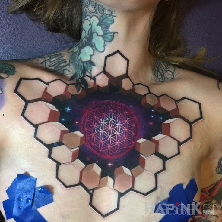 Tattoo Kwiat życia in cosmos motif on the chest