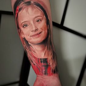 Tattoo Daughter's Portrait, color on the forearm motif: colorful style: realistic