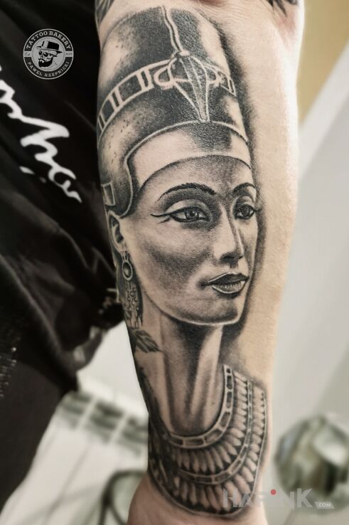 Tattoo Nefretete in faces motif and realistic style On the arm