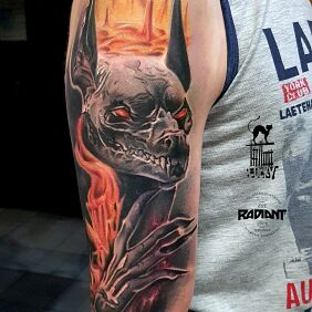 Tattoo Ominous Anubis on the upper arm motif: colorful style: realistic