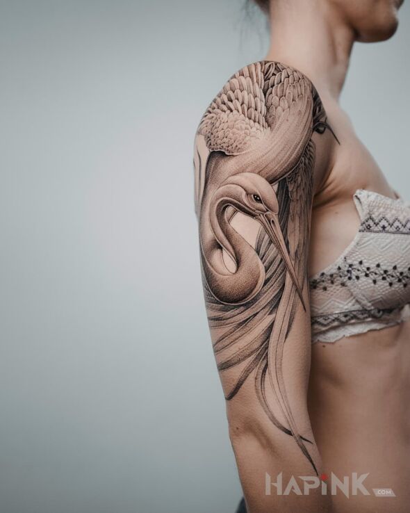 Tattoo Czapla in black and gray motif and realistic style on the upper arm