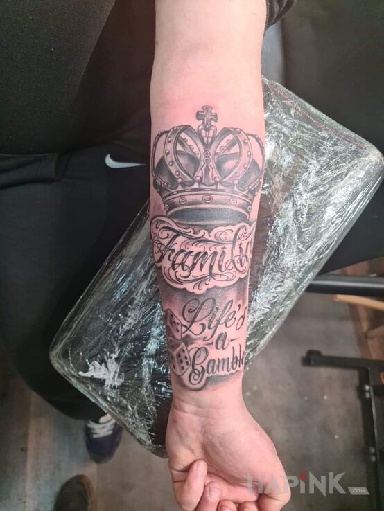 Tattoo Nowy 2022 in casino motif and calligraphy style On the arm
