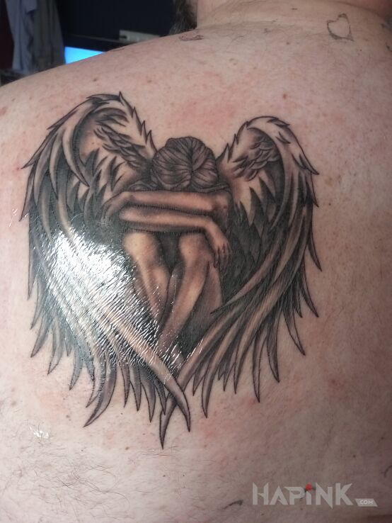 Tattoo Pierwszy tatuaż in black and gray motif and realistic style on the shoulder blades
