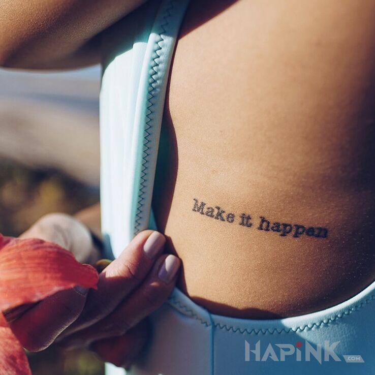 Tattoo Make it happen in lettering motif on the ribs