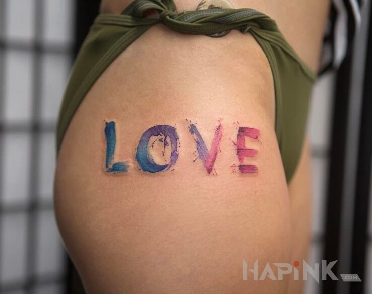 Tattoo LOVE in colorful motif and Watercolor style on the leg