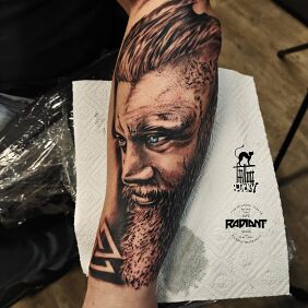 Tattoo Ragnar on the forearm motif: characters style: realistic