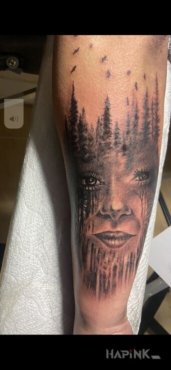 Tattoo Twarz w drzewach in faces motif and realistic style On the arm