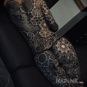 Tattoo Geometry with a lot of black ink on the back motif: mandalas style: geometric