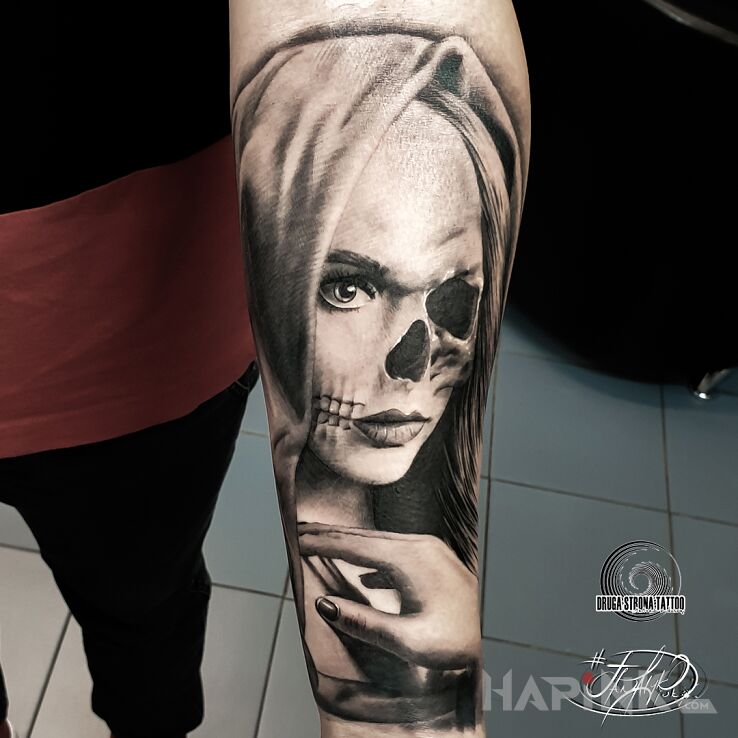 Tattoo Kobieta o dwóch twarzach in religious motif and realistic style On the arm