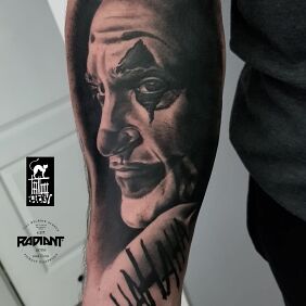 Tattoo Joker Joaquin Phoenix on the forearm motif: faces style: realistic