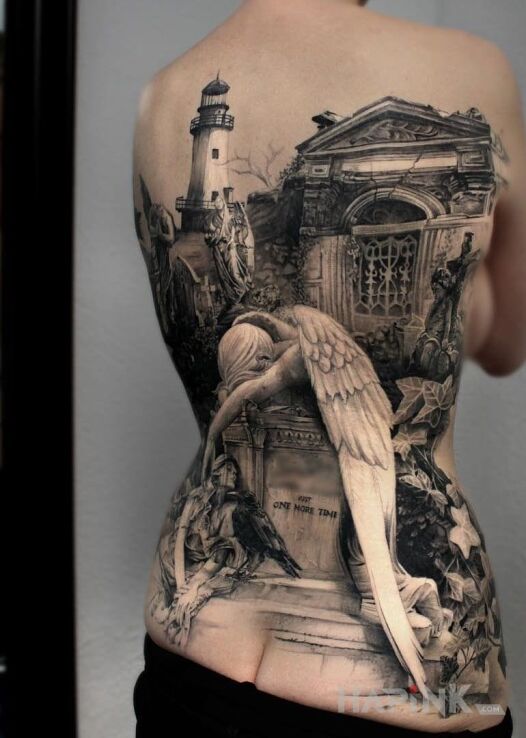 Tattoo Smutny anioł in religious motif and realistic style on the back