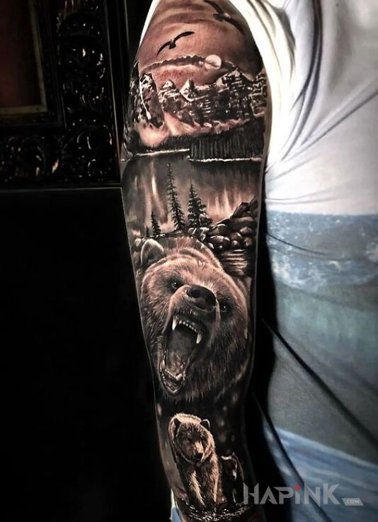 Tattoo Dzika fauna in black and gray motif and realistic style on the upper arm