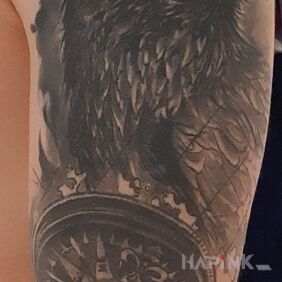 Tattoo Black Compass Bird On the arm motif: objects style: realistic