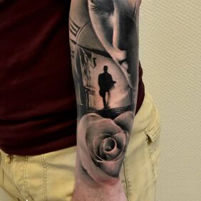 Tattoo Black silhouette in the distance On the arm motif: black and gray style: realistic