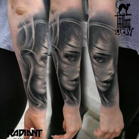 Tattoo A woman's face in shades of gray On the arm motif: black and gray style: realistic