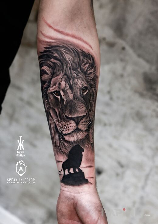 Tattoo Lew in black and gray motif and realistic style On the arm