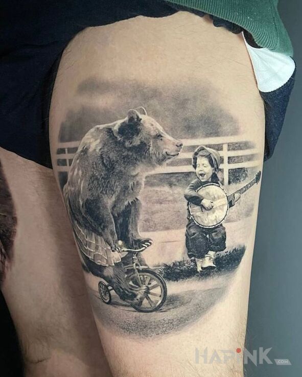Tattoo Niedzwiedz na rowerku in black and gray motif and realistic style on the thigh