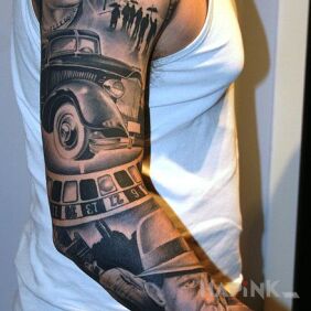 Tattoo Old car and roulette on the upper arm motif: black and gray style: realistic