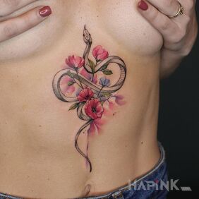 Tattoo Blurred flowers and a little snake on the stomach motif: animals style: Watercolor