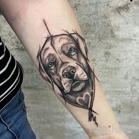 Tattoo Doggy On the arm motif: black and gray style: graphic / illustrative