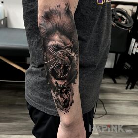 Tattoo Lion heart on the forearm motif: black and gray style: realistic