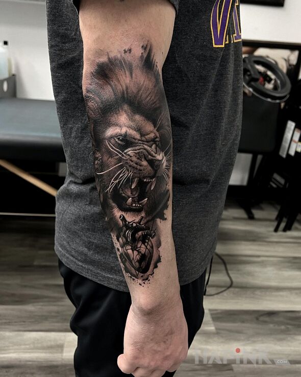 Tattoo Lwie serce in animals motif and realistic style on the forearm