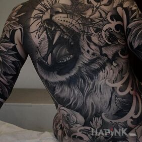 Tattoo Tiger's roar on the shoulder blades motif: black and gray style: realistic