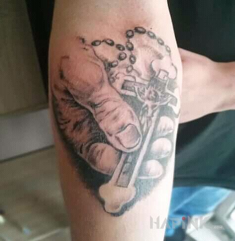 Tattoo Tematyka Religijna in black and gray motif and realistic style On the arm