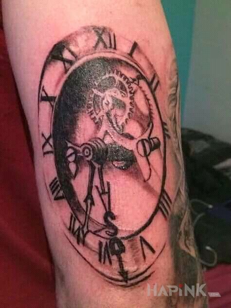 Tattoo Zegar i trybiki in black and gray motif and realistic style on the upper arm