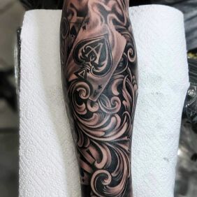 Tattoo Ace of cards on the forearm motif: floral style: realistic