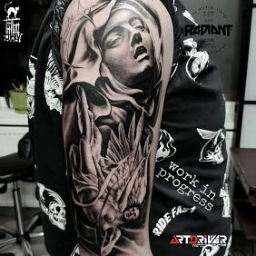 Tattoo Fallen Angel on the upper arm motif: black and gray style: realistic
