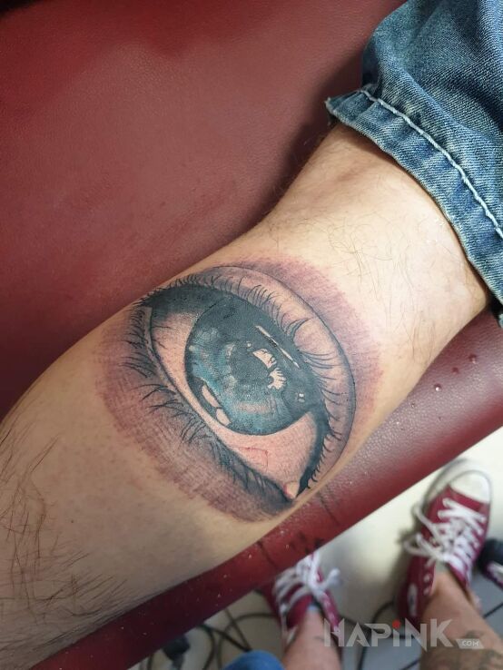 Tattoo Oko in other motif and realistic style on the calf