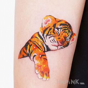 Tattoo Little Tiger On the arm motif: colorful style: graphic / illustrative