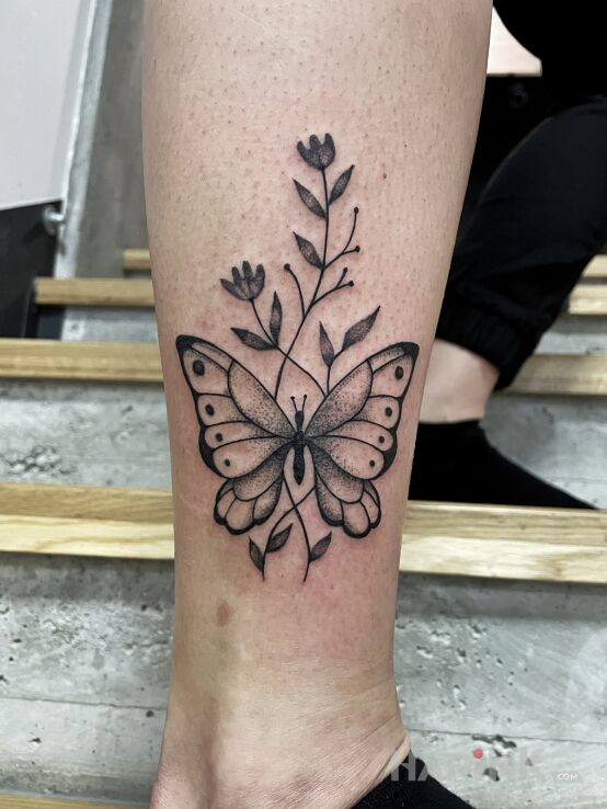 Tattoo Butterfly in animals motif and dotwork style on the leg
