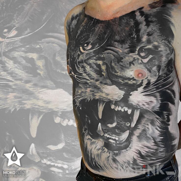Tattoo Lew in animals motif and realistic style on the collarbone