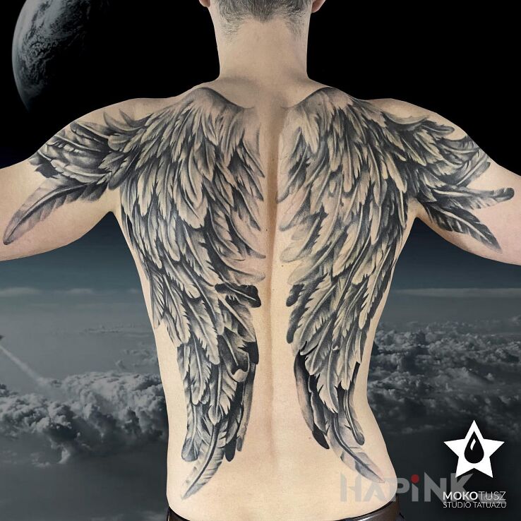 Tattoo I believe I can fly ;) in wings motif and realistic style on the shoulder blades