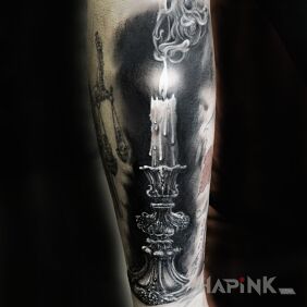 Tattoo Burning candle on the forearm motif: black and gray style: realistic