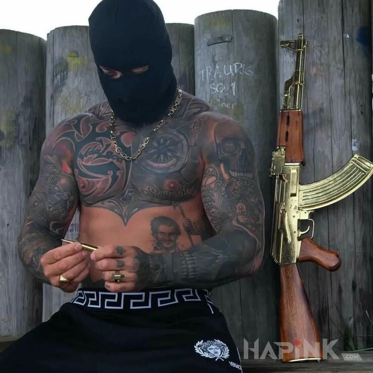 Tattoo Bandyta in skulls motif and tribal style on the upper arm