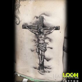 Tattoo Crucifixion. Jesus on the cross. on the back motif: religious style: realistic