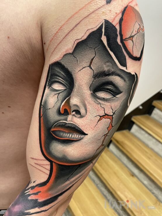 Tattoo Face Tattoo in faces motif and neo-traditional style on the upper arm