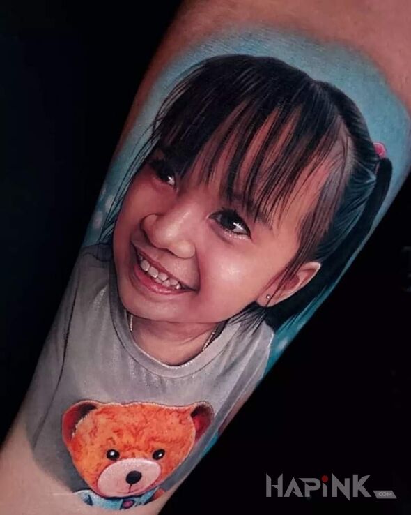Tattoo Niesamowity portret małej dziewczyny in faces motif and realistic style On the arm