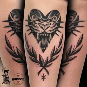 Tattoo Serco-beast and wreath on the tibia motif: black and gray style: graphic / illustrative