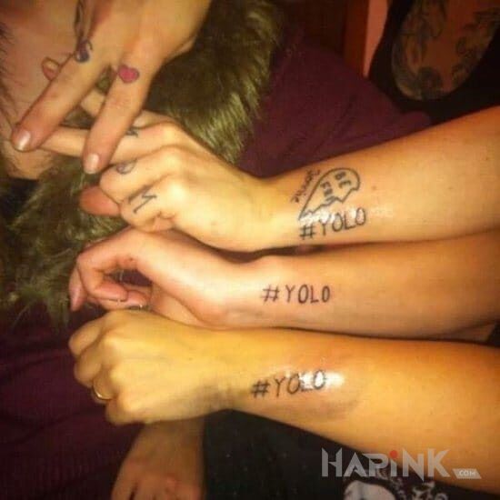 Tattoo #yolo in lettering motif on the forearm