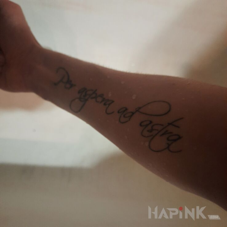 Tattoo Per Aspera Ad Astra in lettering motif and calligraphy style on the forearm