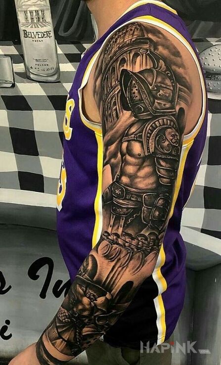 Tattoo Spartakus in black and gray motif and realistic style on the upper arm