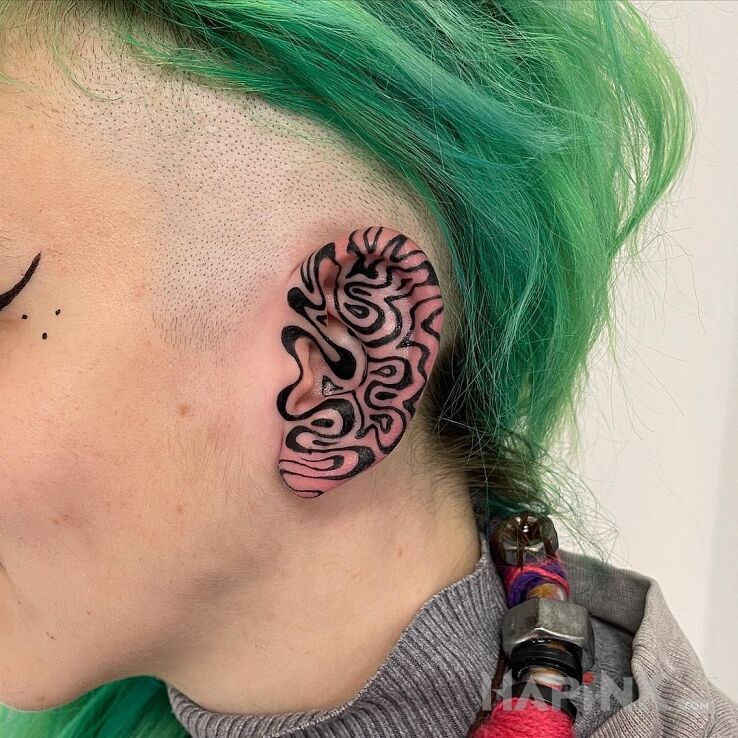 Tattoo Szalone ucho in other motif and blackwork / blackout style behind the ear