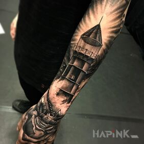 Tattoo Lighthouse on the hand motif: flowers style: realistic