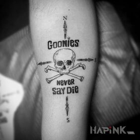Tattoo Goonies never say die on the forearm motif: skulls